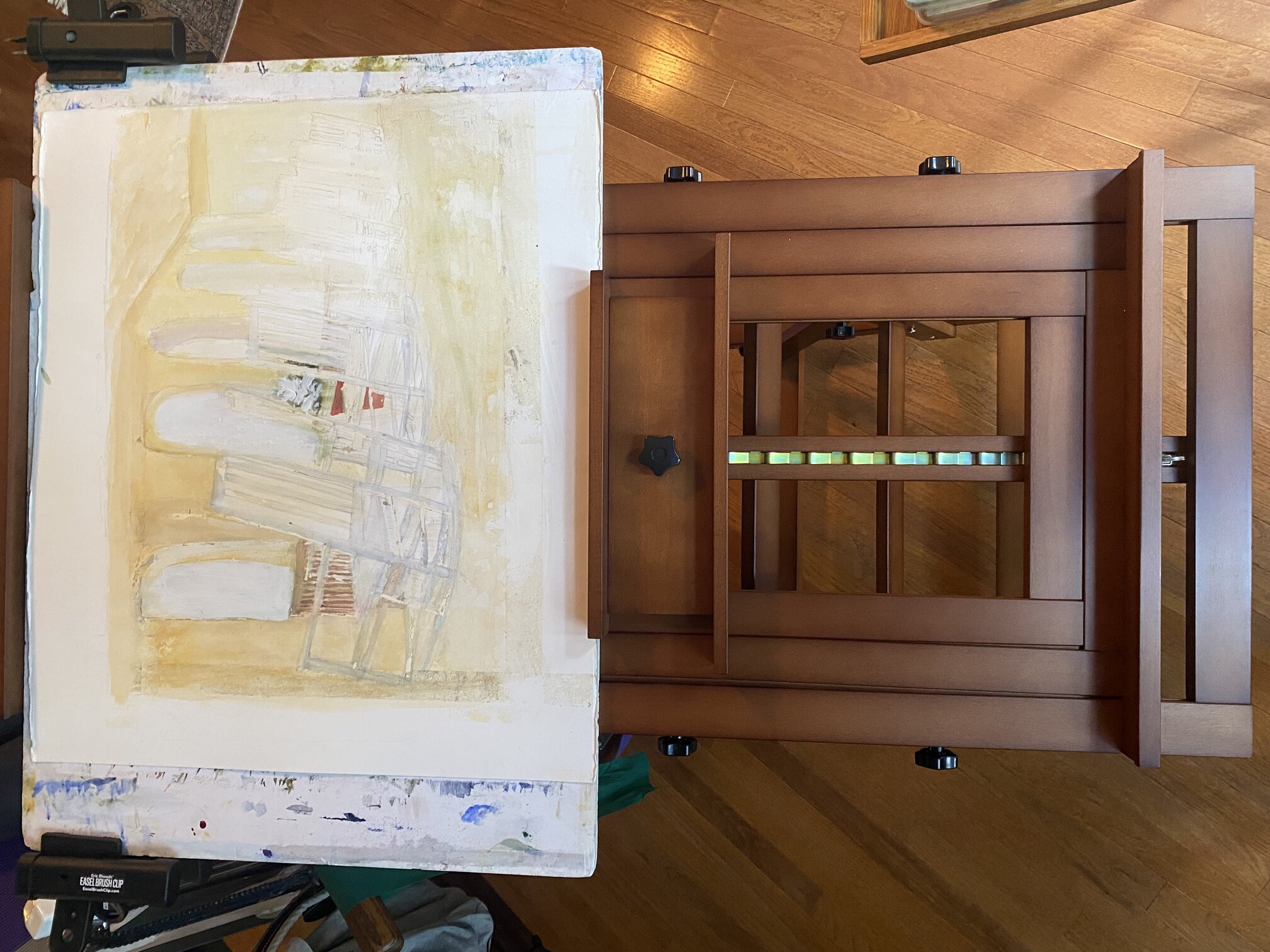 Watercolor in progress showing porch rocking chairs on an easel